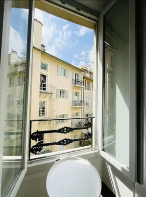 a white toilet in a room with a window at Studio en plein centre de Nice, proche Tramway in Nice