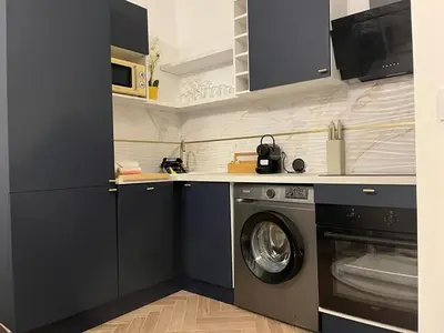 a kitchen with a washing machine and a microwave at MOON - 31 in Nice