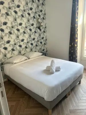 a bed with two towels on it in a bedroom at MOON - 31 in Nice