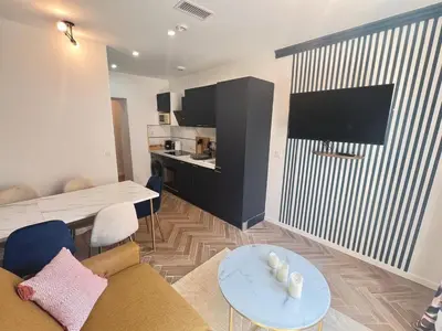 a living room with a couch and a table at MOON - 37 in Nice