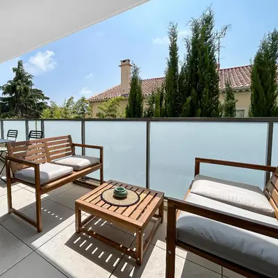 a balcony with two chairs and a table at Spacieux T2 à 150m Des Plages in Cagnes-sur-Mer