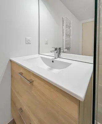a bathroom with a white sink and a mirror at Spacieux T2 à 150m Des Plages in Cagnes-sur-Mer