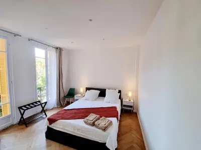 a bedroom with a bed with two towels on it at Spacious Family Apartment Near Sea - Nice in Nice