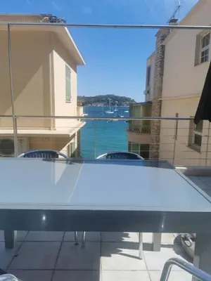 a ping pong table on a balcony with a view of the water at Villa Ninette avec rooftop in Villefranche-sur-Mer