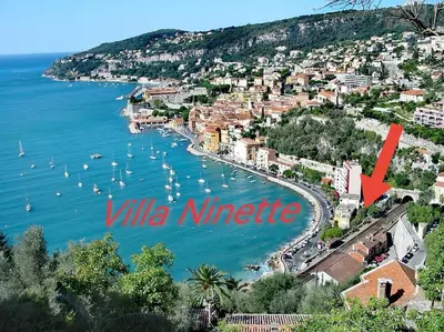 a view of a harbor with boats in the water at Villa Ninette avec rooftop in Villefranche-sur-Mer