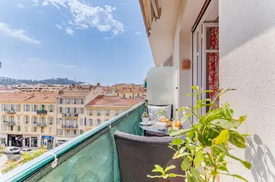 a balcony with a table and a view of a city at LE LAFAYETTE 2 AP4474 by Riviera Holiday Homes in Nice