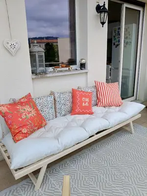 a white couch with colorful pillows on a porch at Stunning 2 bedroom apartment with Terrace and Sea view, Nice Cimiez Liberation in Nice