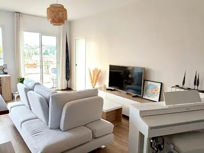 a living room with a white couch and a white piano at Stunning 2 bedroom apartment with Terrace and Sea view, Nice Cimiez Liberation in Nice