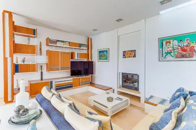a living room with a couch and a tv at VILLA DYONIS VI4439 by Riviera Holiday Homes in Nice