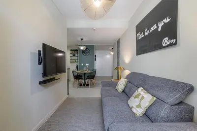 a living room with a blue couch and a television at Appartement confort centre ville de Nice in Nice
