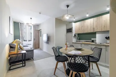 a kitchen and living room with a table and chairs at Appartement confort centre ville de Nice in Nice