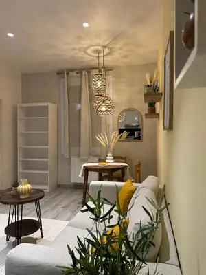 a living room with a couch and a table at Nice Jussieu 2 pièces entièrement rénové in Nice