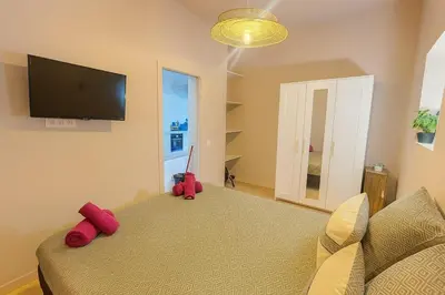 a bedroom with a bed with red stuffed animals on it at Central- walk to Massena & Beach in Nice
