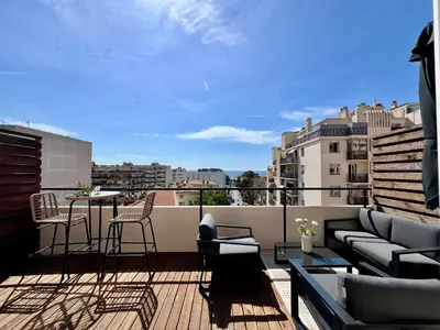 a balcony with a couch and a table and chairs at TheNiceTerrace in Nice