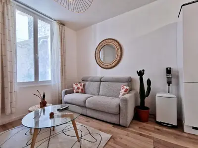 a living room with a couch and a glass table at Cosy Savoie by Bookking Guys in Nice