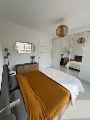 a bedroom with a bed and a mirror at 2 Pièce - Promenade des Anglais in Nice
