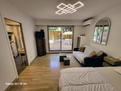 a living room with a bed and a couch at Ferber Garden - Appartement de charme avec deck privé in Nice