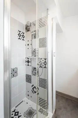 a shower stall with black and white tiles at Nice Renting - 35b MASSENA - Chic Cosy Calm Balcony Massena Pedestrian Heart in Nice