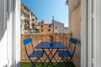 a blue table with chairs and a cactus on a balcony at Nice Renting - 35b MASSENA - Chic Cosy Calm Balcony Massena Pedestrian Heart in Nice