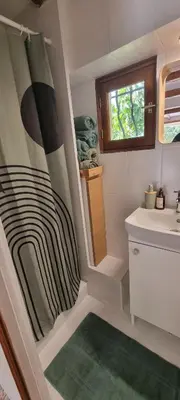 a bathroom with a sink and a shower curtain at Le Jas in Tourrette-Levens