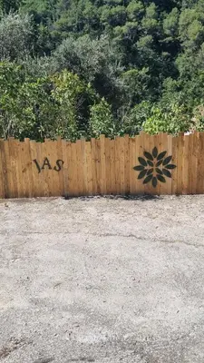 a wooden fence with graffiti on the side of it at Le Jas in Tourrette-Levens