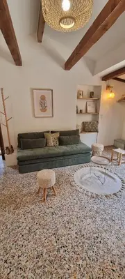 a living room with a green couch and two chairs at Le Jas in Tourrette-Levens