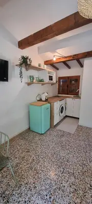 a kitchen with a blue refrigerator in a room at Le Jas in Tourrette-Levens