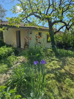 a garden in front of a house with flowers at Le Jas in Tourrette-Levens