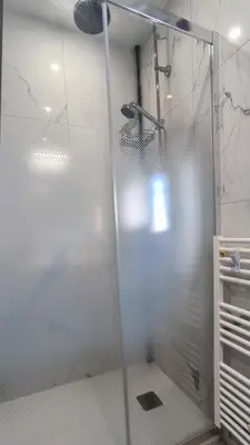 a shower with a glass door in a bathroom at Studio La Madrague Côte d'Azur in Cros-de-Cagnes