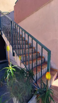 a set of stairs next to a building with flowers at Studio La Madrague Côte d'Azur in Cros-de-Cagnes