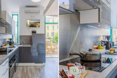 a kitchen with white cabinets and a stove top oven at MY CASA - CASSINI - Garibaldi Square - AC in Nice