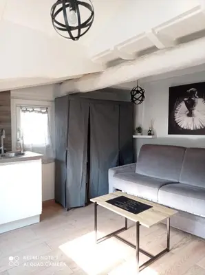 a living room with a couch and a table at Studio dernier étage vieux Nice centre in Nice