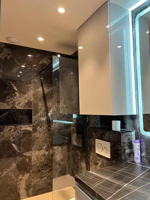 a bathroom with a glass shower and a cabinet at Grand Studio Luxe in Nice