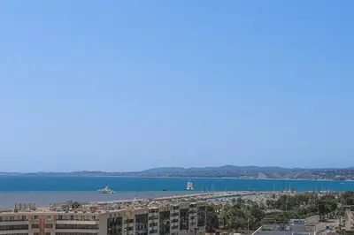 a view of a beach and the water with buildings at Ciel d'Azur - Climatisé piscine partagée in Saint-Laurent-du-Var