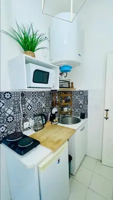 a coffee maker and a cup on a counter at Studio in the center balcony AC in Nice