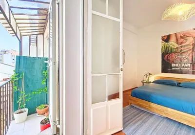 a bedroom with a bed and a door to a balcony at Nestor&Jeeves - PALAIS DE LA SIRENE - Near Promenade des Anglais in Nice