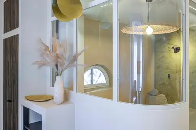 a bathroom with a mirror and a vase on a counter at Grand appartement Centre de Nice in Nice