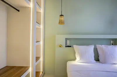 a bedroom with a bed with white pillows at Grand appartement Centre de Nice in Nice
