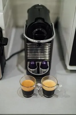 two cups of coffee sitting on top of a blender at Le Chic, appartement plein centre avec Climatisation in Nice