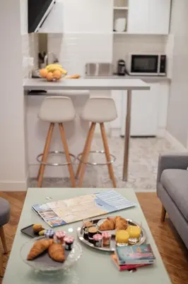 a table with a plate of food on top of it at Le Chic, appartement plein centre avec Climatisation in Nice