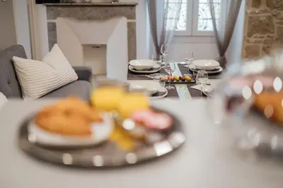 a table with plates of food on top of it at Le Chic, appartement plein centre avec Climatisation in Nice