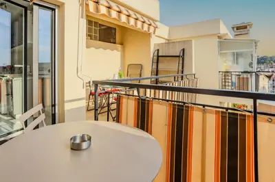 a table on the balcony of a building at Studio Terrace AC Lift - Old town | By Airnest in Nice