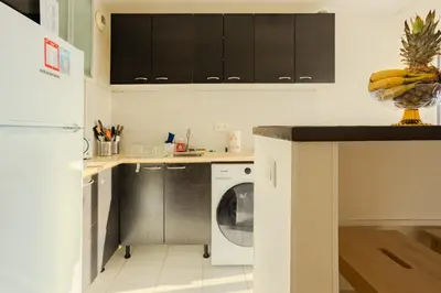 a kitchen with a washer and a dishwasher at Studio Terrace AC Lift - Old town | By Airnest in Nice