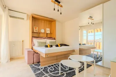 a bedroom with a bed and a table and chairs at Studio Terrace AC Lift - Old town | By Airnest in Nice
