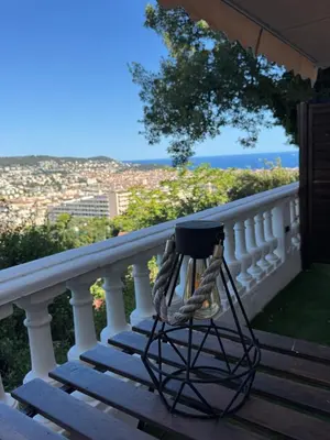a wooden deck with a fire pit on a house at Villa Baie Des Anges in Nice