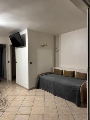 a bedroom with a bed and a flat screen tv at Villa Baie Des Anges in Nice