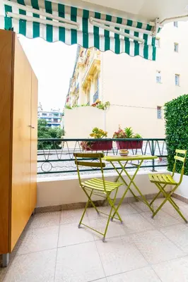 a table and chairs on a balcony with a view at Oasis Azur 1 min from the beach in Nice