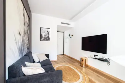a living room with a couch and a tv at Oasis Azur 1 min from the beach in Nice