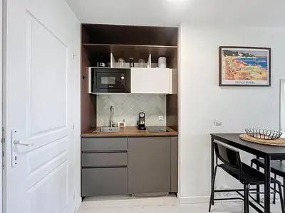 a small kitchen with a sink and a microwave at Studio Neuf avec Terrasse et Aperçu Mer in Nice