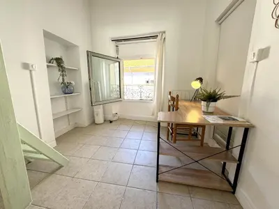 a dining room with a table and a window at C OT Maison de la Place - Old Town in Nice